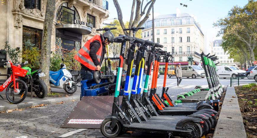 Dépose de trottinettes Dott par un employé.